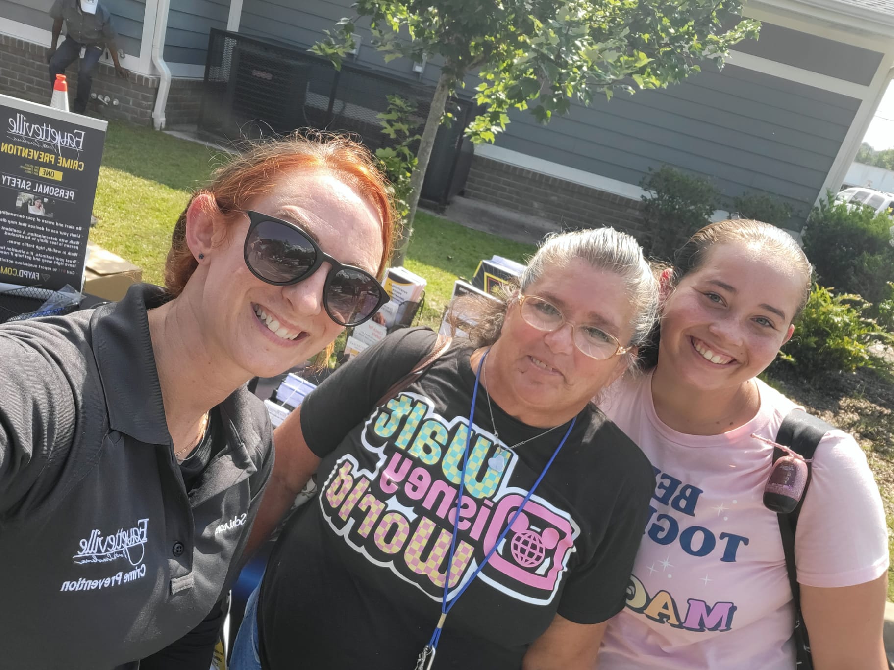 Crime Prevention Specialist standing with two woman.