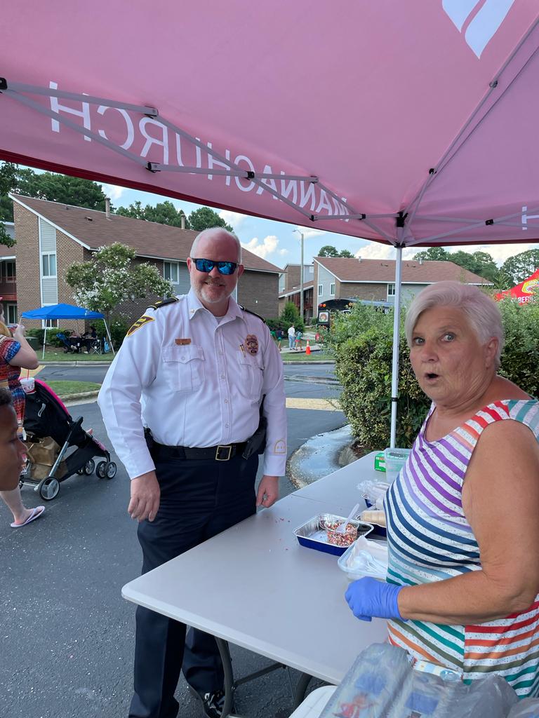 Fayetteville Police Major standing next to a female from the community